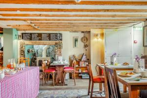 a dining room with tables and chairs and a room with a table at Tiger Inn - Catherine in Eastbourne