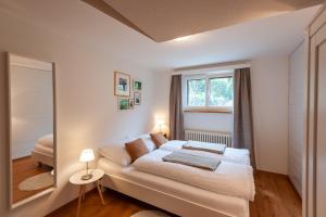 a bedroom with a bed and a large mirror at Sonnenkreisel Ferienhaus in Triesen