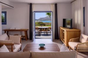 a living room with a view of the ocean at White Dream Suites Antiparos in Andiparos