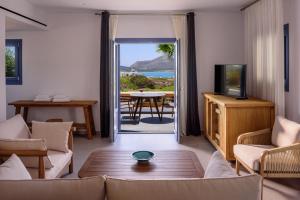 a living room with a view of the ocean at White Dream Suites Antiparos in Antiparos