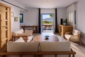 a living room with a couch and a table at White Dream Suites Antiparos in Antiparos