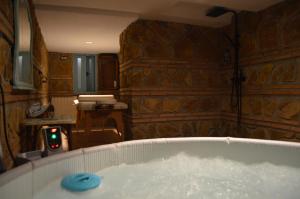 a bath tub filled with water in a room at Apartamentos El Aljibe Relax Tourist Cordoba in Córdoba
