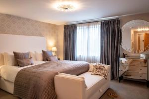 a bedroom with a large bed and a mirror at Harbour View in Lymington