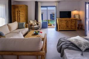 a living room with a couch and a table at White Dream Suites Antiparos in Antiparos