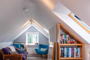 a childs room with a book shelf and a window at Harbour View in Lymington