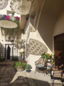 an outdoor patio with chairs and tables and plants at Borgo San Gaetano in Bernalda