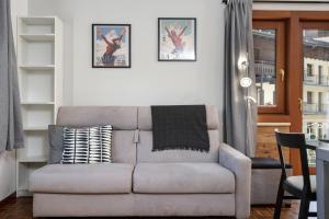 a living room with a couch and a table at HelloChalet - Chez León in Valtournenche