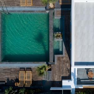 an overhead view of a swimming pool in a building at White Dream Suites Antiparos in Antiparos