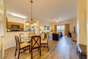 a kitchen and living room with a table and chairs at Exquisite 3 Bdr Condo Minutes to Disney in Orlando