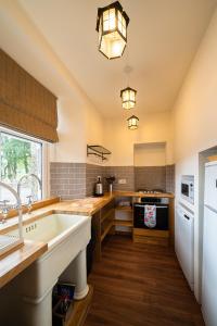 a large kitchen with a sink and a stove at The Bothy, Gallin, Glenlyon, Perthshire 
