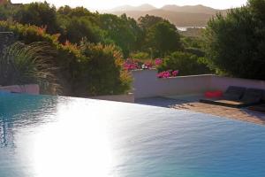 una piscina con vistas a las montañas en Hôtel Maora Village, en Bonifacio