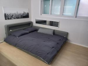 a bed with two pillows and a bed frame in a room at Newly Renovated 2 Bedroom Apartment in Seoul