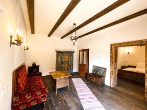 a living room with a couch and a bed at Castle View Saschiz - Traditional Guesthouse in Saschiz