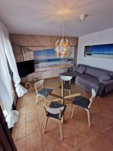 un soggiorno con divano, tavolo e sedie di Casa Fuerte Aventura a Lajares