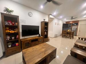 a large living room with a flat screen tv at PANGSAPURI MIDAS in Johor Bahru