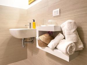 a bathroom with a sink and towels on a wall at Idiana Bed and Breakfast in LʼAquila +36 photos
