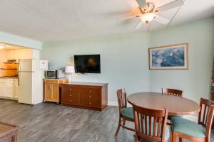 a living room with a dining room table and a kitchen at Wildwood Condo with Pool Access - Walk to Beach! in Wildwood