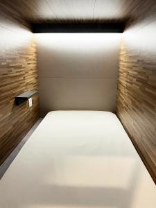 a bedroom with a white bed with a light on it at Seoul Cube Jongro in Seoul