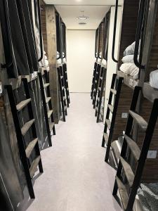 a hallway of a room with rows of bunk beds at Seoul Cube Jongro in Seoul
