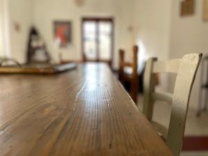 a wooden table and chairs in a room at Appartamento in Piazza Spolethome in Spoleto