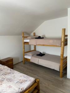 a room with two bunk beds and a room with two beds at Jaćimov Konak in Pirot