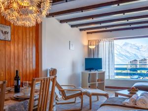 a living room with a chandelier and a table and chairs at Apartment Christiania 2 L3 by Interhome in Nendaz