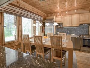 a kitchen with a dining room table and chairs at Holiday Home Kannelpirtti 2 by Interhome in Puromäki
