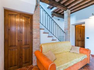 a living room with a couch and a staircase at Holiday Home Villa Caggio-4 by Interhome in Volterra