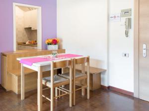 a kitchen with a table with a pink cloth on it at Apartment Comfort by Interhome in Riva del Garda