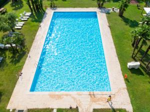 an overhead view of a large blue swimming pool at Apartment Comfort by Interhome in Riva del Garda
