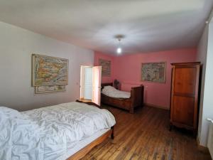 a bedroom with pink walls and a bed and a window at Holiday Home Le Patio by Interhome in Saint Malo +22 photos