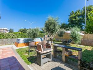 a backyard with a table and chairs and a tree at Holiday Home Dream House by Interhome in Follonica
