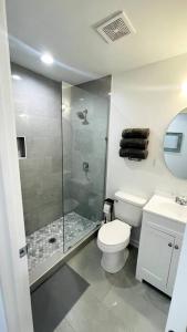 a bathroom with a shower and a toilet and a sink at Modern Home Near Uptown CLT, Airport and More in Charlotte +47 photos