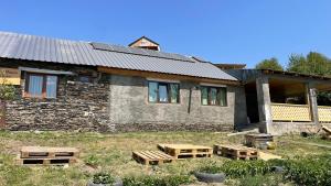 a stone house with benches in front of it at lileo in Omalo