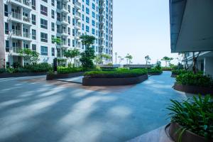 a courtyard in a building with plants and buildings at Tokyo Riverside Apartment @ PIK 2 in Tangerang