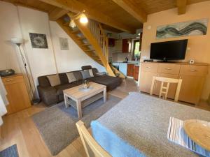 a living room with a couch and a table at Apartmán Donovaly Mišuty 586 in Donovaly