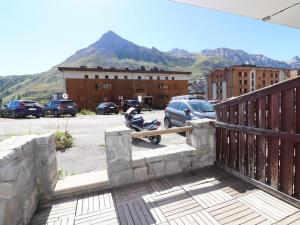 a motorcycle parked on a ramp in a parking lot at Studio rénové à Tignes Le Lac, proche pistes et commerces, balcon et terrasse privative - FR-1-502-425 in Tignes +2 photos