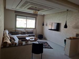 a living room with a couch and a table at Couzi Haus Marina in Agadir