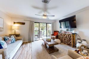 a living room with a couch and a table at Portside Resort E2 in Panama City Beach