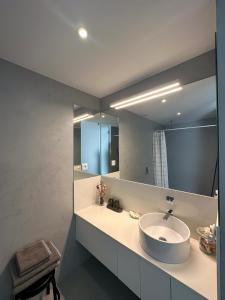 a bathroom with a sink and a large mirror at Casa Sousa - 3rd generation (Apart.2) in Boticas