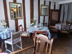 a dining room with tables and chairs and a mirror at The Swan Inn in Harwich