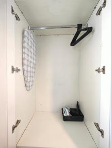 a walk in shower with white walls and chrome fixtures at Charming Holiday Studio in Hazel Grove - Self Catering Apartment 2 in Hazel Grove