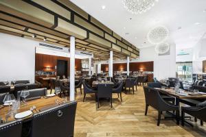 a restaurant with tables and chairs and a bar at Fairmount Hotel in San Antonio