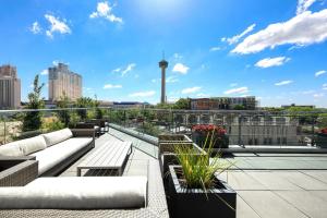 a rooftop patio with couches and a view of a city at Fairmount Hotel in San Antonio