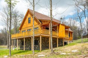 a large wooden house with a wrap around deck at Johns Place in McHenry