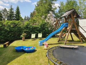 a playground with a slide and a play set at Domek Sasanka in Kościelisko
