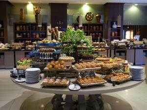a table filled with different types of pastries and desserts at Qafqaz Tufandag Mountain Resort Hotel in Gabala +41 photos