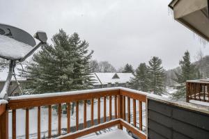 a deck covered in snow with trees and houses at Villages of Wisp 08 Winding Way in McHenry