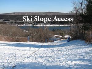 a sign that says ski slope access in the snow at Villages of Wisp 08 Winding Way in McHenry