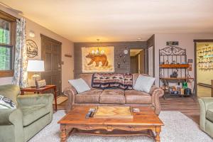 a living room with a couch and a coffee table at Woodside Retreat in McHenry